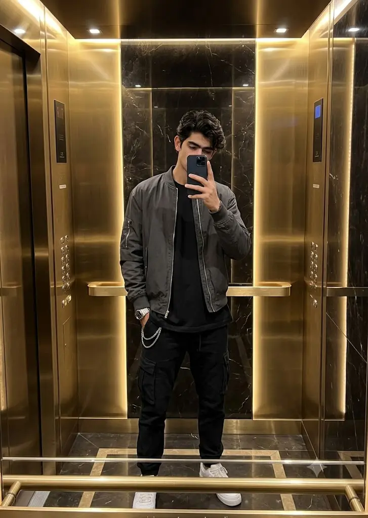 Luxury hotel elevator mirror selfie of a stylish boy in oversized streetwear generated using a Gemini AI prompt.